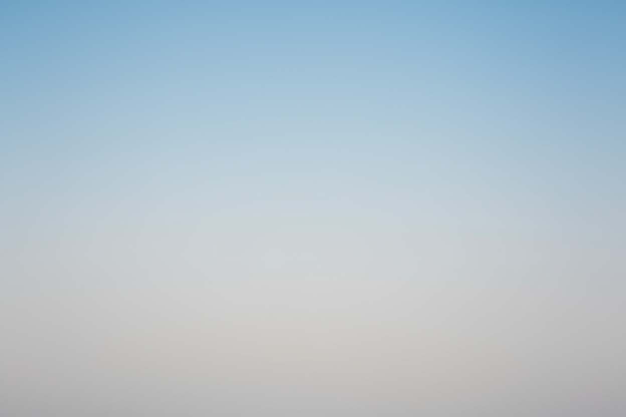 Gradient background transitioning from light blue to light grey