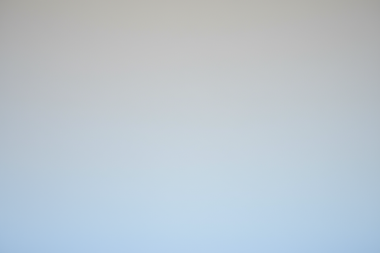 Gradient background transitioning from light gray to light blue